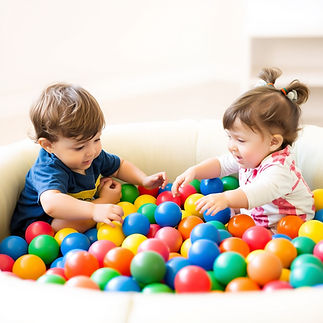 2 children playing in a ball pit.jpg