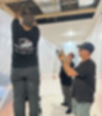 Revelation Plumbing putting up plastic during a whole house waterline repipe to protect the home in pittsburgh from debris.