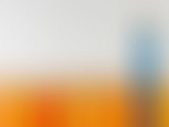A group of orange pencils with one tall blue pencil standing out, symbolizing leadership and distinction