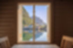 Open window view of the sea, a village, and surrounding mountains in Norway