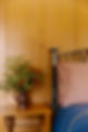 Artisan iron headboard and handcrafted linens in wine country boutique hotel stay.