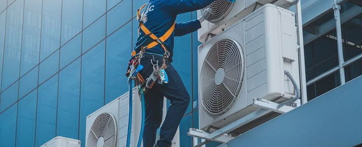 man is repairing ac