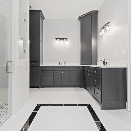 sleek black cabinets and white countertops in bathroom