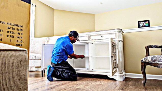 Furniture Assembler assembling a TV stand