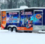 Mobile gaming truck with colorful sports and gaming graphics parked in snowy wooded setting. Text: Mobile Gaming, parties, festivals.
