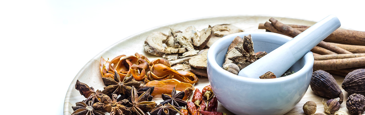 A photo of Herbal medicine in wood dish on white isolate background with space for text.jp