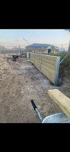Installing concrete sleepers into heavy-duty steel posts for a structural retaining wall in the Hunter Valley.