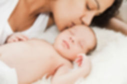 Mother kissing baby