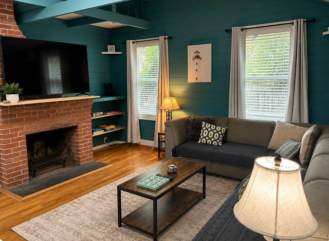 Greenish teal blue painted living room of Sea La Vie in Fire Island, NY