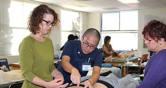 acupuncture doctor teaching a classroom of students
