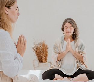 Reiki teacher and student with hands in Gassho