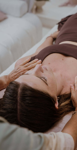 Reiki client receiving a treatment with practitioner's hands on shoulders
