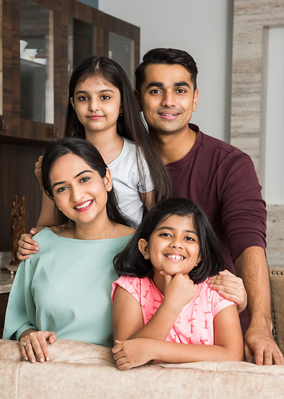 portrait-happy-indian-asian-young-family-while-sitting-sofa-lying-floor-sitting-against-wa