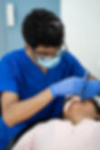 A dentist is providing medical treatment to a patient._edited.jpg