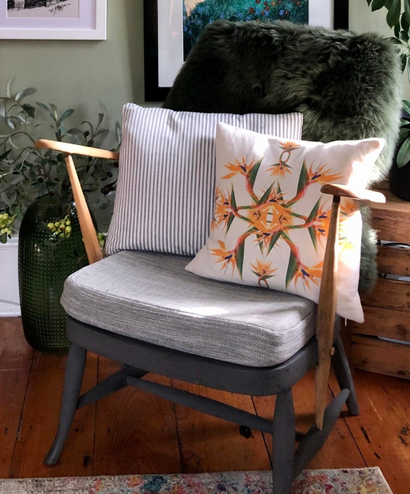 ercol mid-centuary armchair bird of paradise cushion green sheepskin