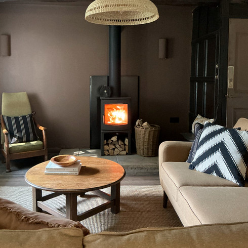 Chocolate brown wall paint and log burner stove