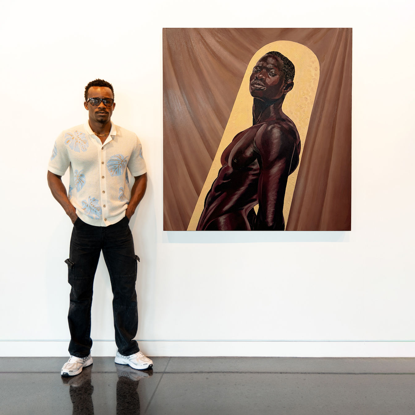 Artist standing beside Presence I portrait in gallery