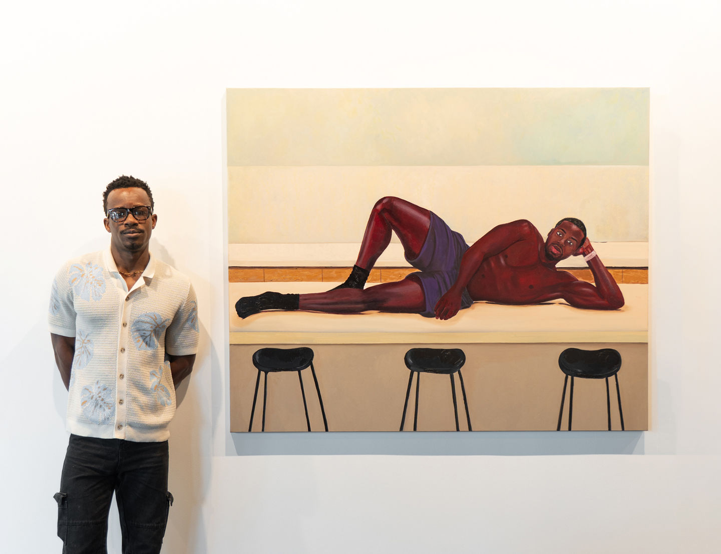 Painting of a man reclining on a counter above bar stools. Painting by Isaiah Philip.