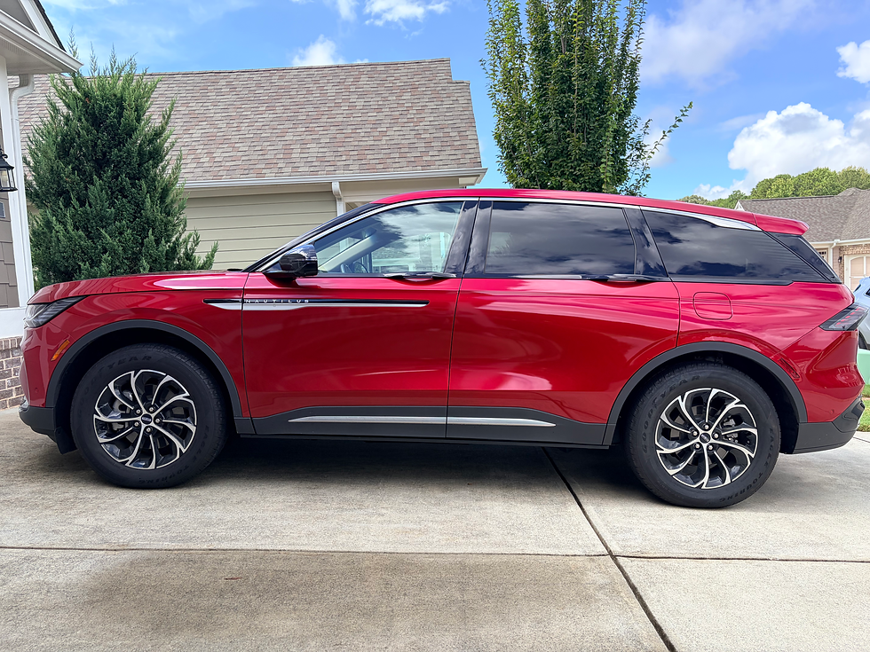 Eye-level view of a 2024 Lincoln Nautilus parked in a clean driveway.