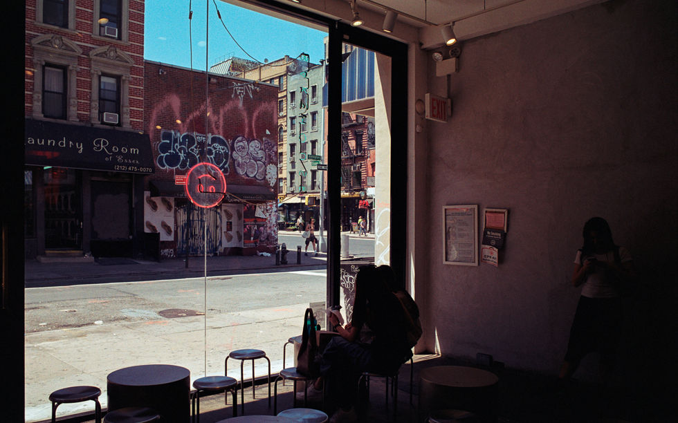 Cafe interior with large window and street view.