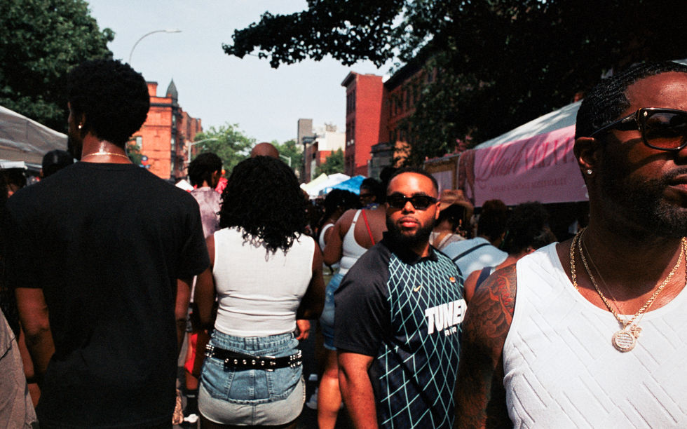 People walking at an outdoor event or festival.
