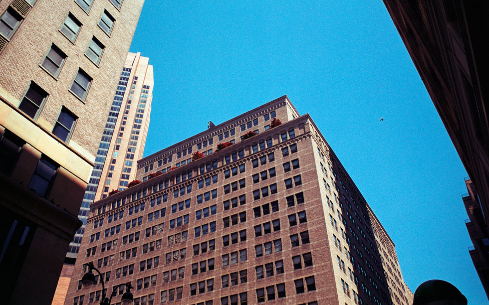 Tall buildings against a clear blue sky.