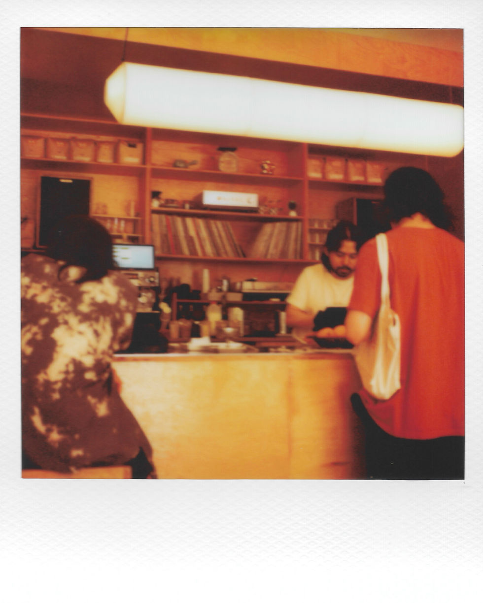 People at a cozy coffee shop counter.