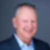 Headshot of smiling man in suit
