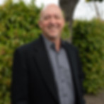 Smiling man in suit outdoors