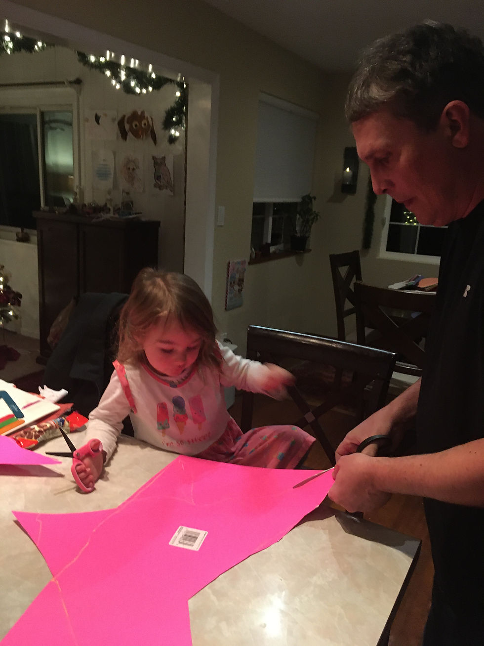 Picture of a dad helping toddler make a glitter star.
