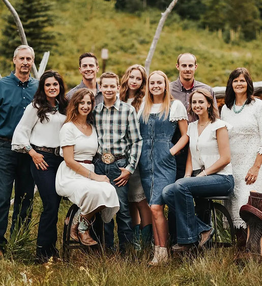 Outside family photo of 10 on the ranch with four males and 6 females.