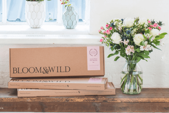 Bloom and wild flowers on a wooden table