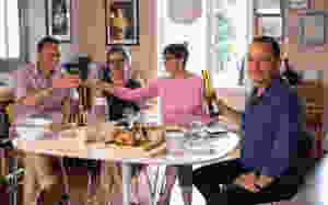 nick curtis the journalist eating lunch with friends while watching revels in hand perform at his home