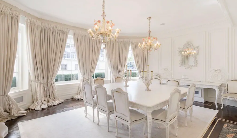 Stunning white room in palacial airbnb in Mayfair with white table and 10 chairs