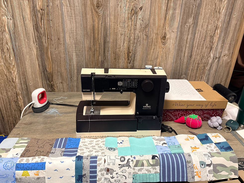 My mom's old sewing machine that I learned to sew on approximately 30 years ago. First couple of rows pieced together of the quilt I made with my son's baby clothes, sheets and blankets.