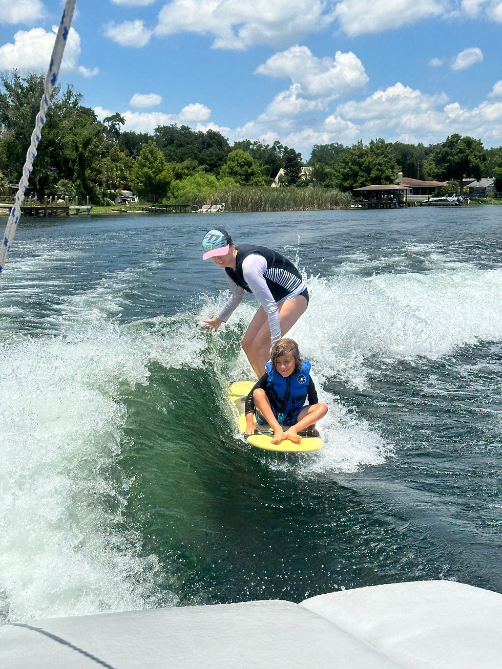 mom and boy surfing on surf board