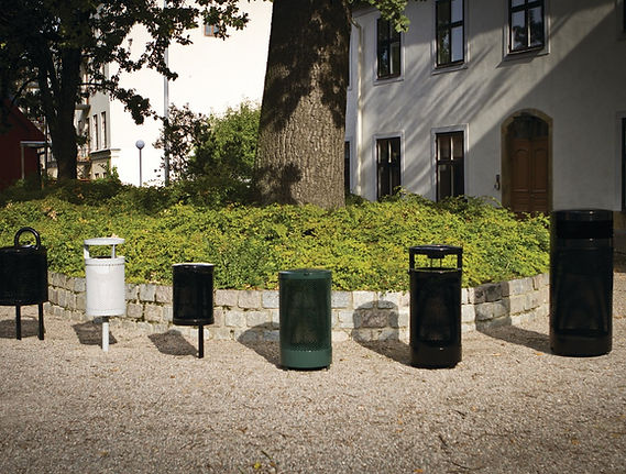 A selection of six litter bins in front of a beautiful house