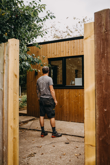 man standing in front of garden room he has built from thermopine panels