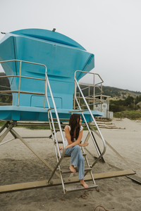 lifeguard stand cloudy senior portrait