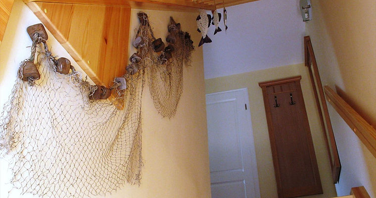 Treppenaufgang zur Ferienwohnung Ostseeblick mit alten Fischernetzen
