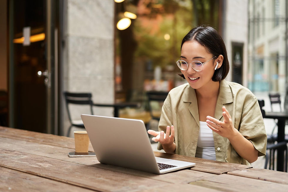 young-woman-sitting-online-meeting-outdoor-cafe-talking-laptop-camera-explaining-something