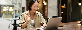 online-meeting-young-urban-girl-asian-woman-talking-with-laptop-video-chat-gesturing-sitti