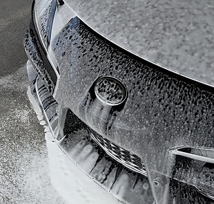 Front end of a Toyota Supra with Foaming soap on it to show off the Showroom Detail