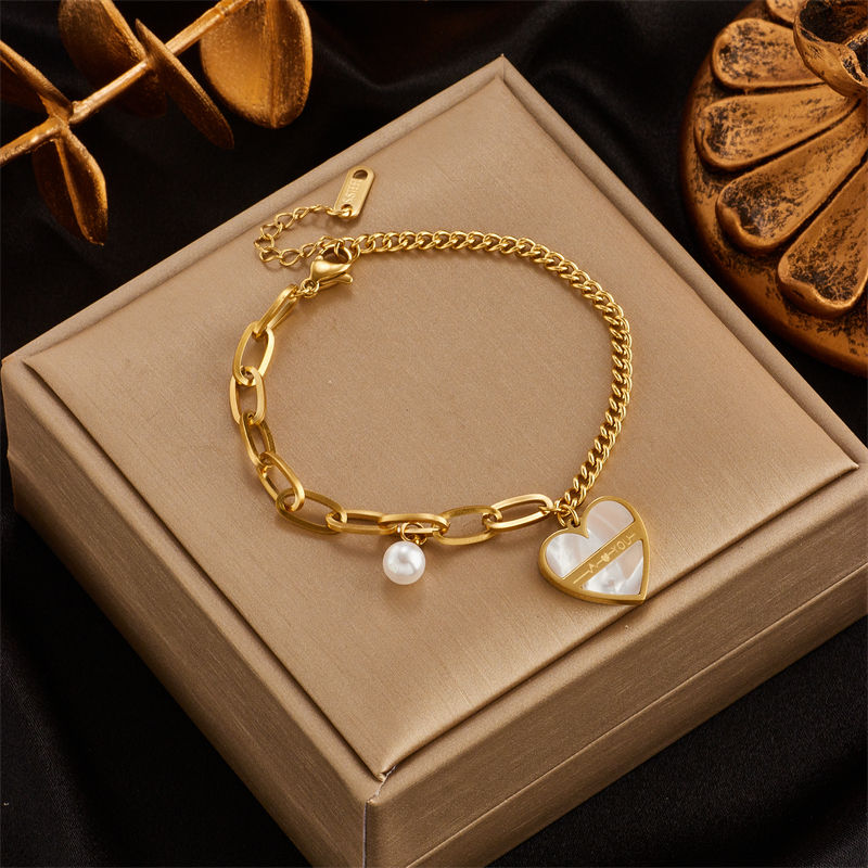 Thumbnail: Women's gold charm bracelet collection in 316L stainless steel with heart, butterfly and textured link designs