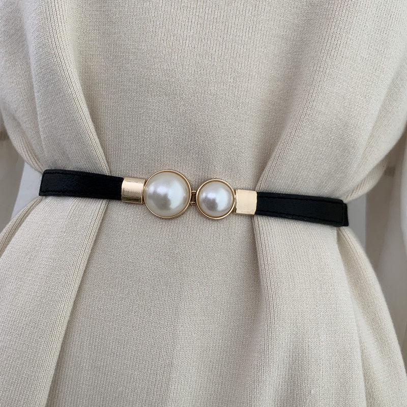 Black PU leather elastic waist belt with pearl detail flat lay