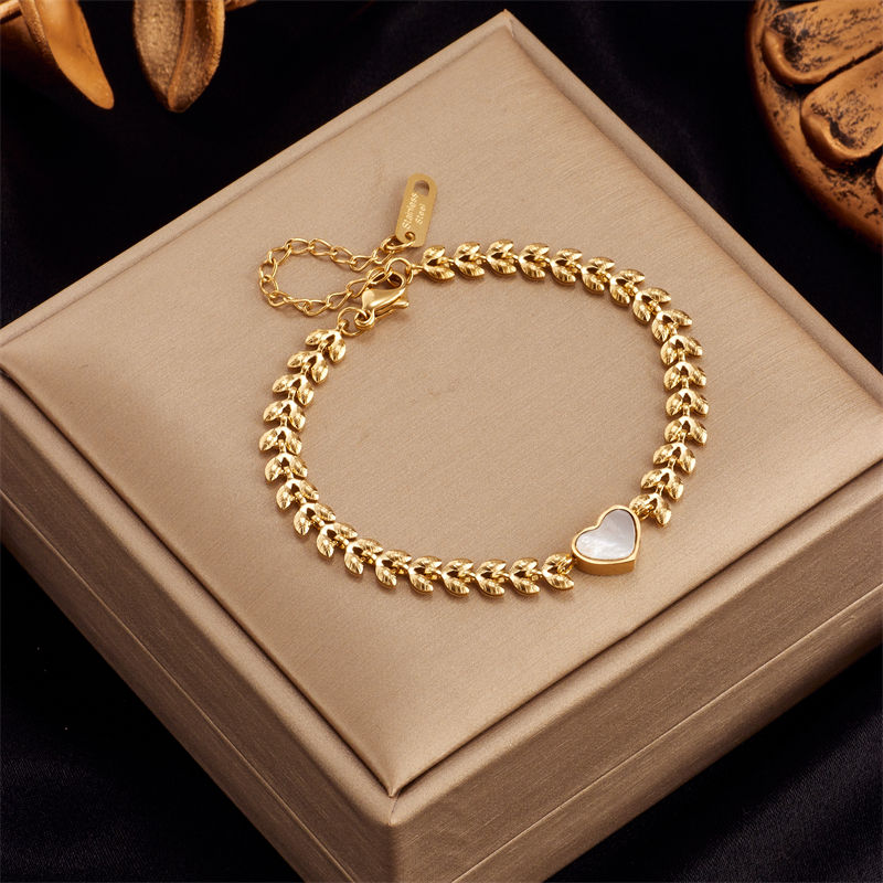Thumbnail: Women's gold charm bracelet collection in 316L stainless steel with heart, butterfly and textured link designs