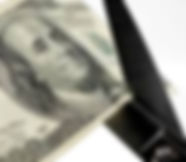 100 dollar bill being cut by scissors