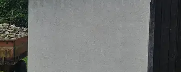 Reprise et pose d'agrafe sur un mur en moellon, scellement au ciment et finition brute au ciment blanc