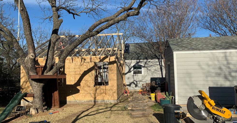 Rear view of house with new addition framing now vertical. 