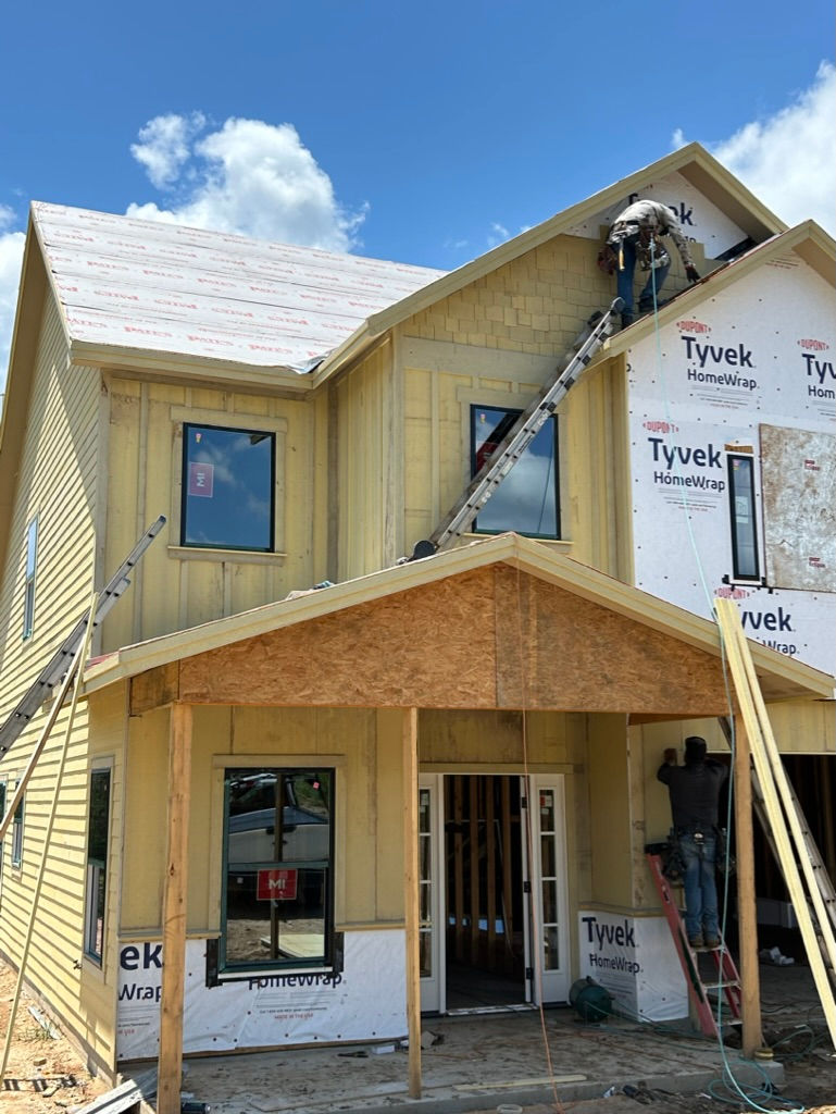 a building under construction with tyvek homewrap on the side